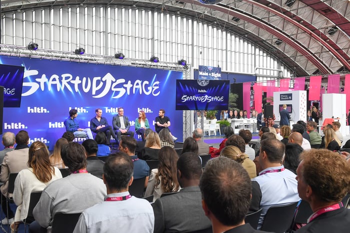 Image of an example of a GES delivered feature area of an event theatre with an audience and speakers on show.