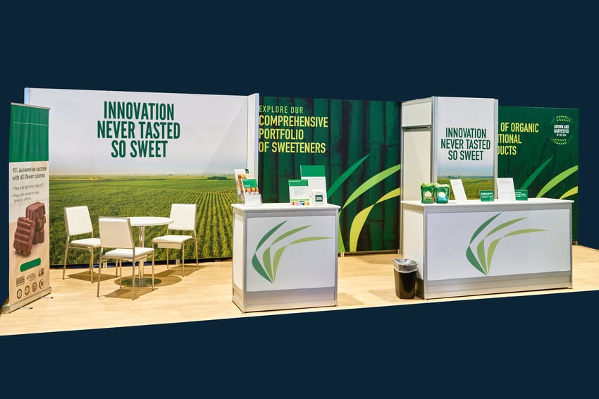 Turnkey Exhibit Systems+ booth with counter, storage, and furniture for small exhibit engagement