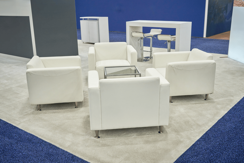 Trade show lounge chairs and coffee table coordinated for a cohesive booth design