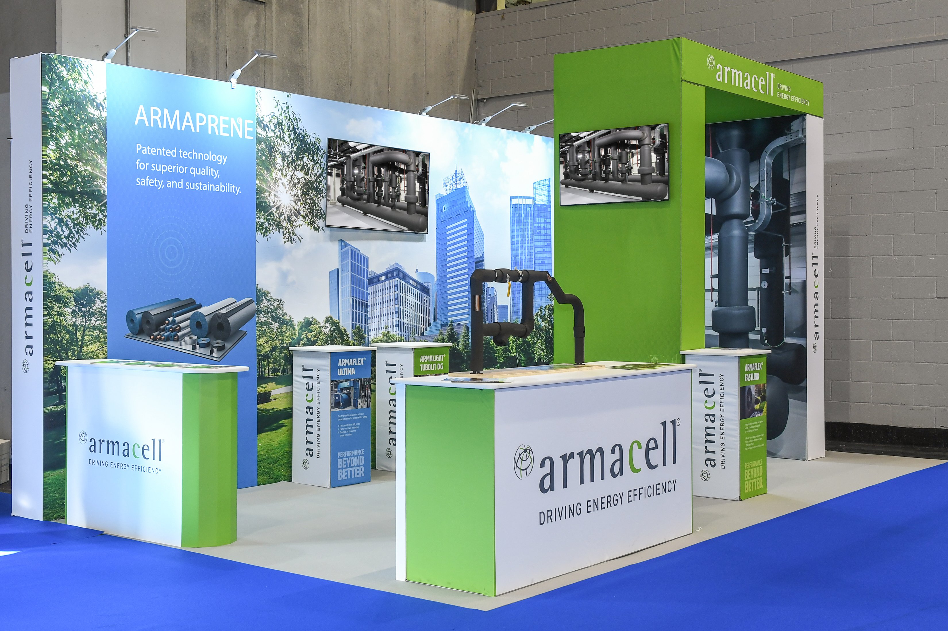A picture of GES' Show Ready Stands, showcasing 'Armacell' the brand at an event with blue vibrant carpet.